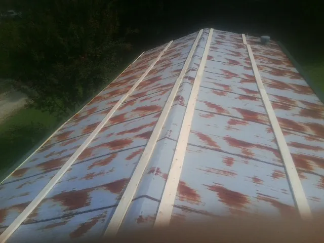 Rusted metal roof panels with new wood purlins before replacement — Storm Damage Roof Repair in Batesburg by Roofing Brothers
