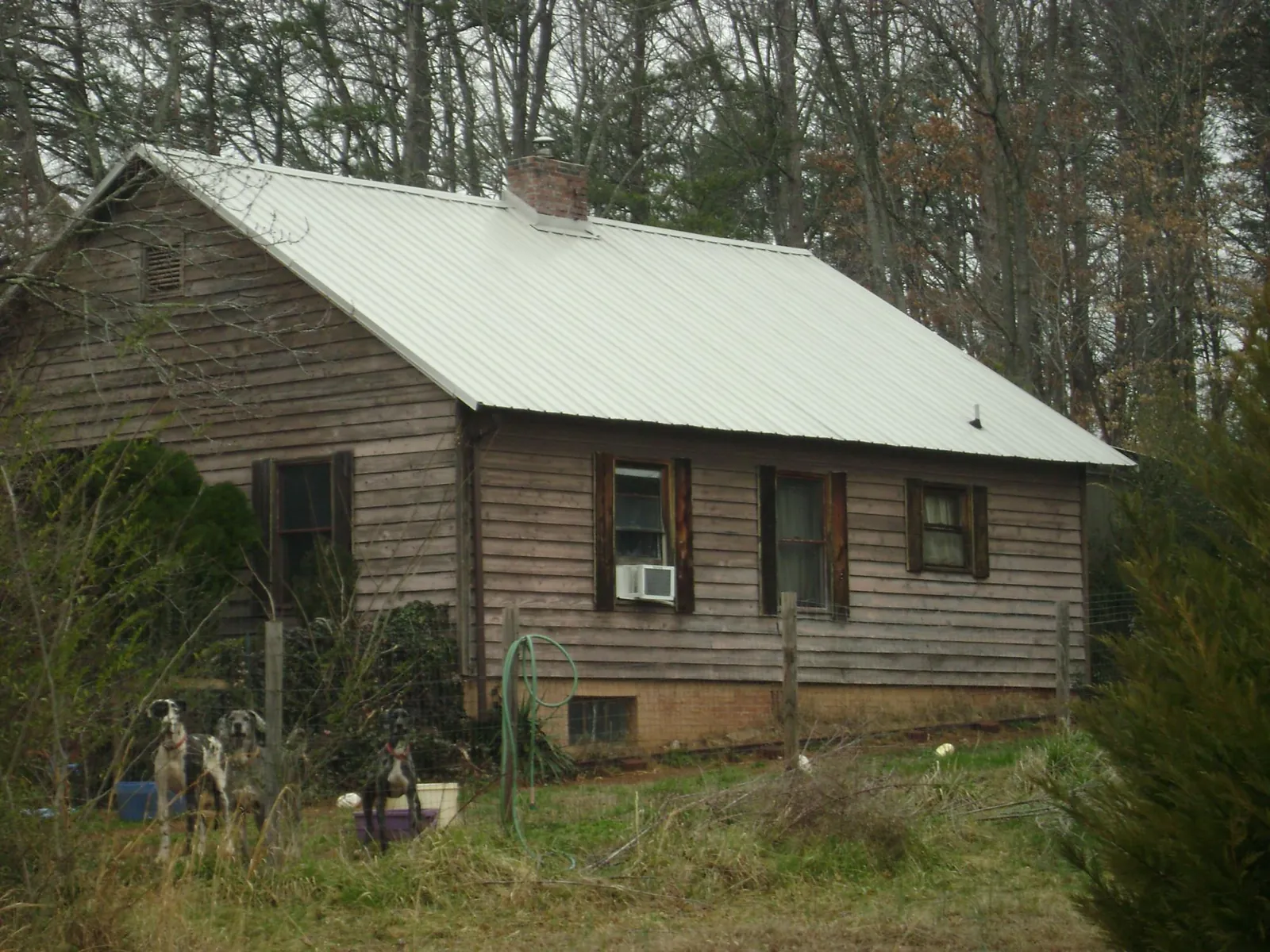 White metal roof on an old wood sided farmhouse, from a Metal Roof Installation job in Batesburg